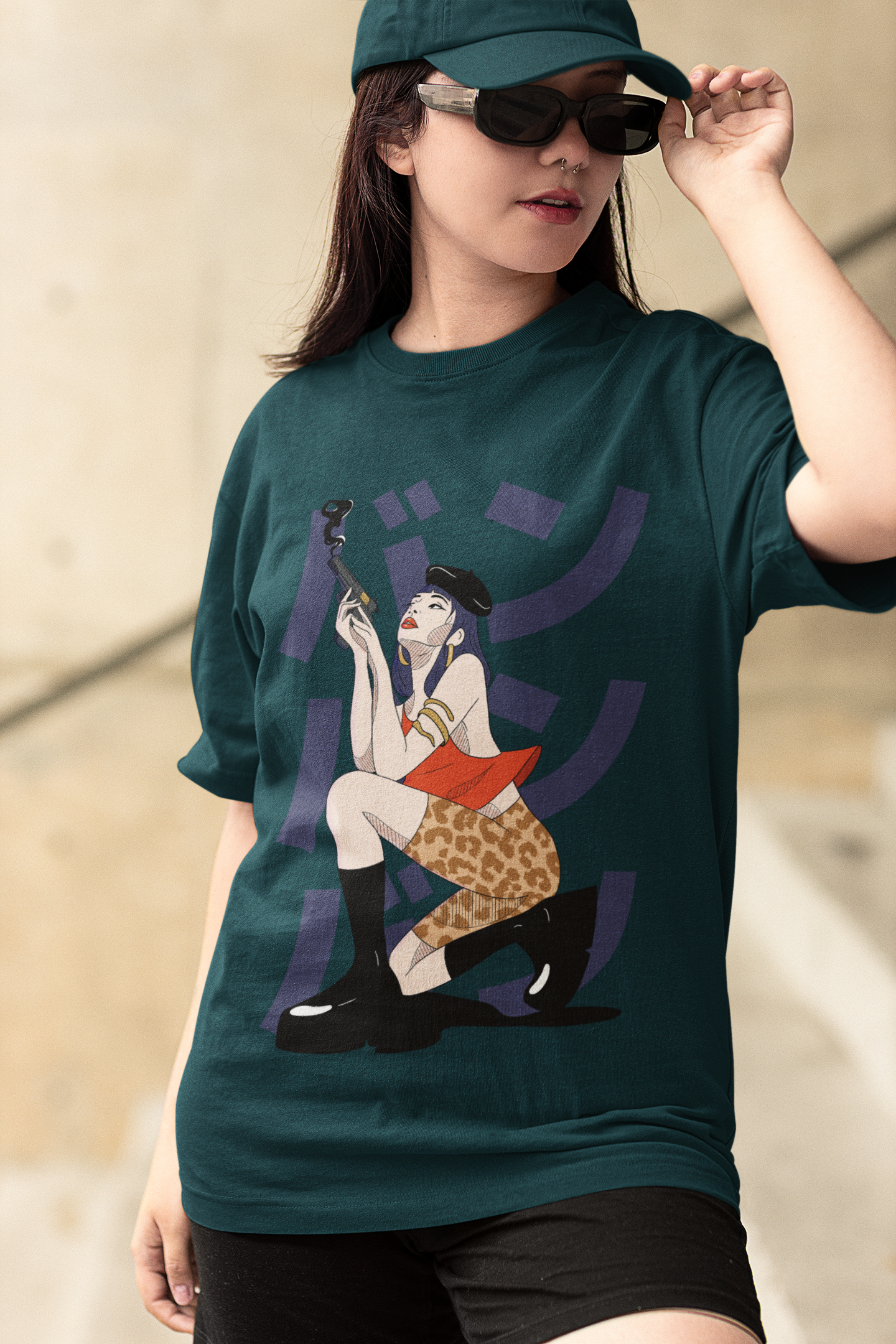 Woman wearing oversized Petrol blue t-shirt with retro anime girl smoking illustration, styled with black shorts, cap, and sunglasses.