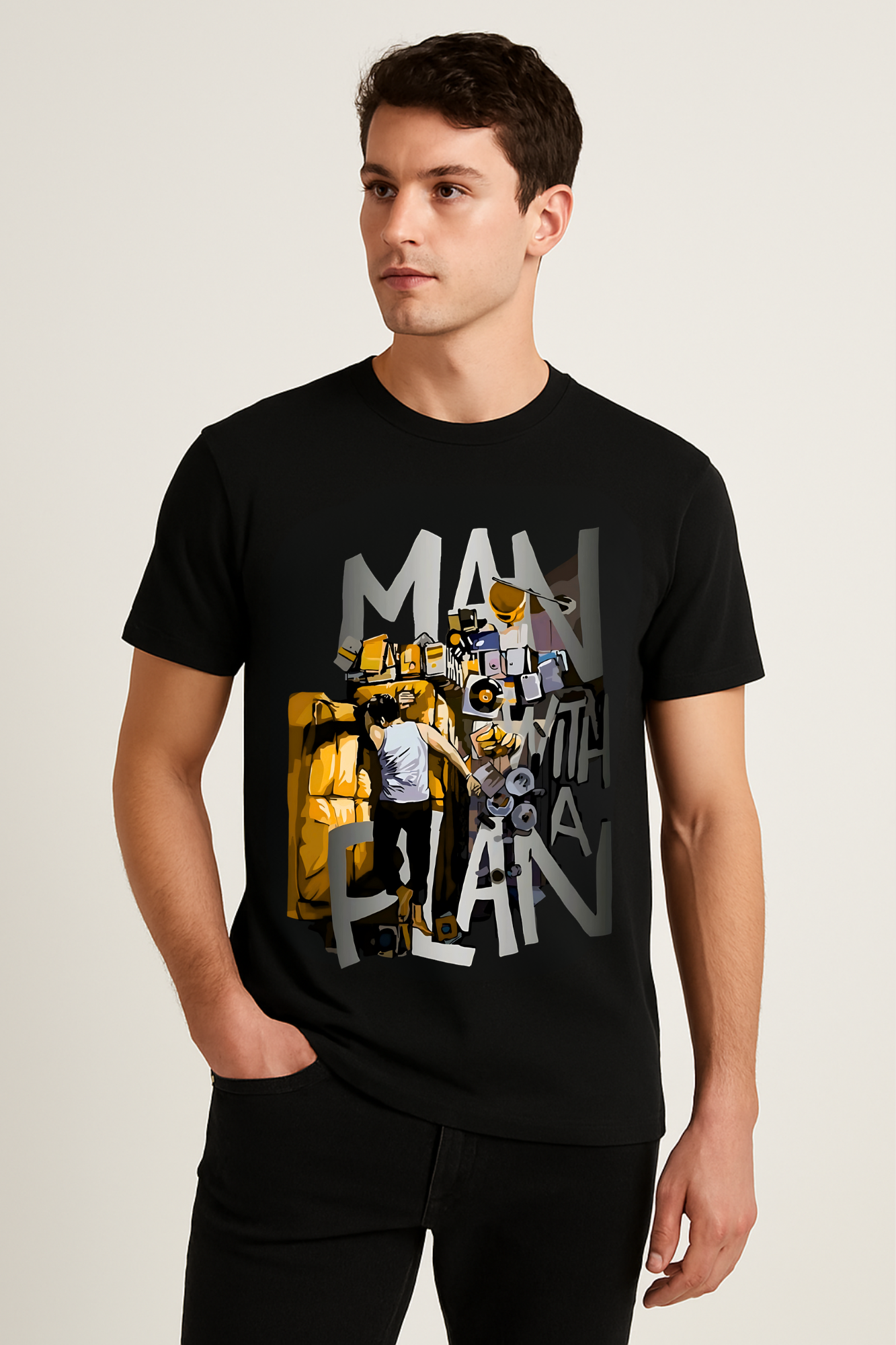 Model wearing black 180 GSM graphic t-shirt with “MAN WITH A PLAN” design, posing in minimal studio with soft lighting.